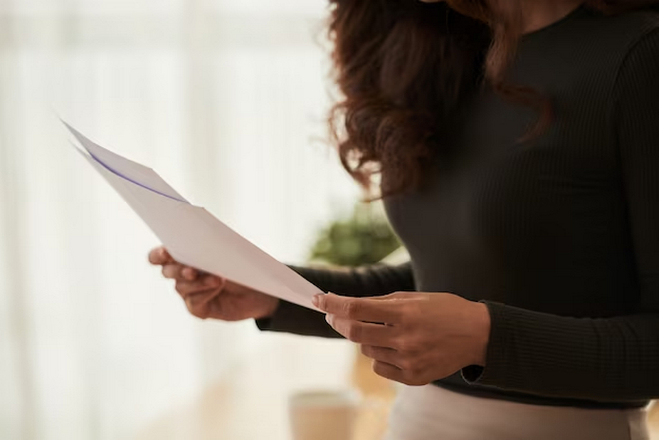 A woman holding a document.