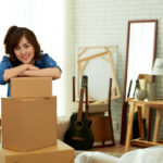 woman leaning on a pile of package boxes