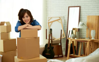 woman leaning on a pile of package boxes
