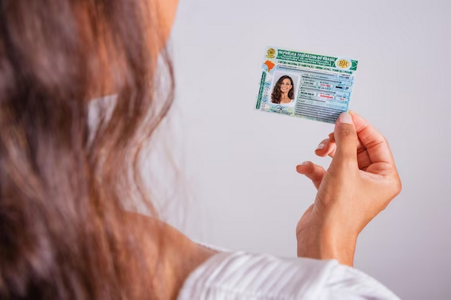 A woman holding her identification (ID) card