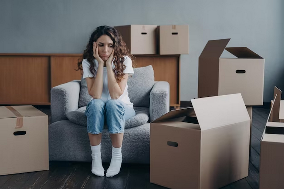Sad Woman Surrounded by Boxes