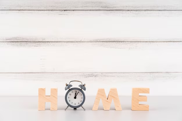 Wooden lettering of the word 'home' with the letter 'o' replaced by a clock.