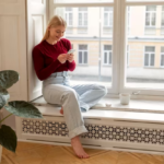 woman with cellphone by the window