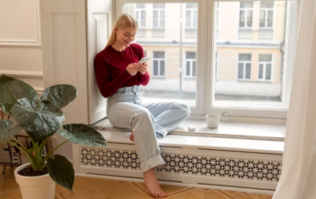 woman with cellphone by the window